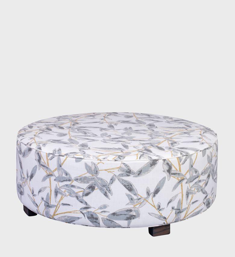 The Cloud Ottoman brings a touch of nature indoors with its soft botanical print in grey and gold tones. Upholstered in a smooth fabric with a circular silhouette