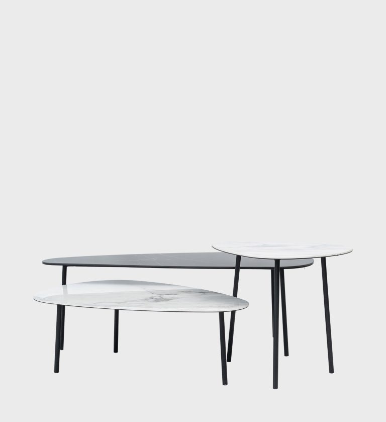 The Odd Shaped Nesting Coffee Table set is a sculptural composition of organic forms and refined materials. Each table features a smooth, asymmetrical top — two in white marble with delicate veining and one in dark stone — supported by slender black metal legs. The layered arrangement creates visual rhythm and versatility, allowing dynamic configurations that suit both minimalist and artistic interiors. A perfect blend of fluid design and modern sophistication.