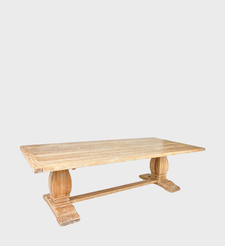 The Refectory Dining Table is a timeless piece that celebrates traditional craftsmanship and enduring design. Its broad rectangular top rests on two sculpted pedestal bases connected by a central stretcher, ensuring both stability and visual balance.