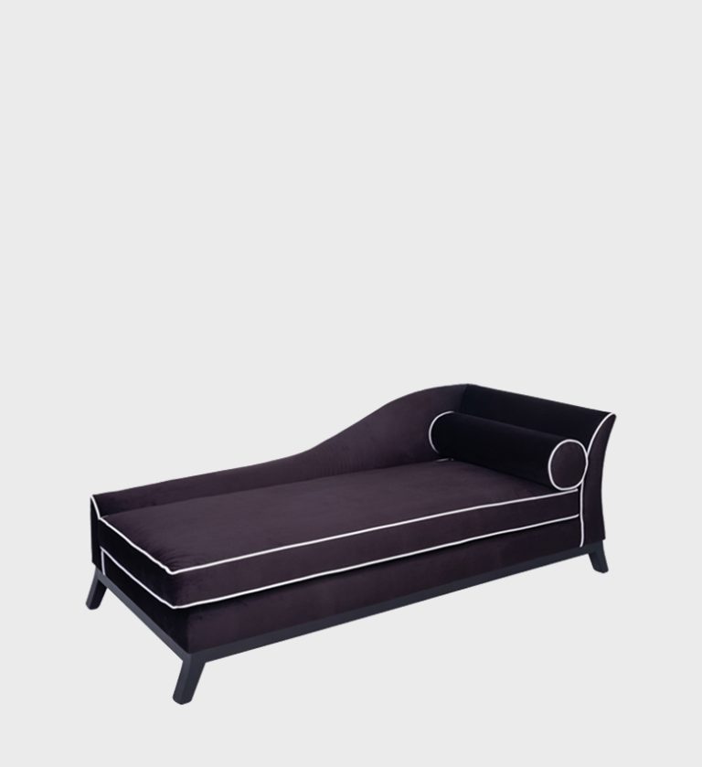 The Diane Daybed captures modern elegance with its sleek silhouette and rich dark‑velvet upholstery. Accented by crisp white piping, its gently curved backrest and cylindrical bolster evoke timeless sophistication.