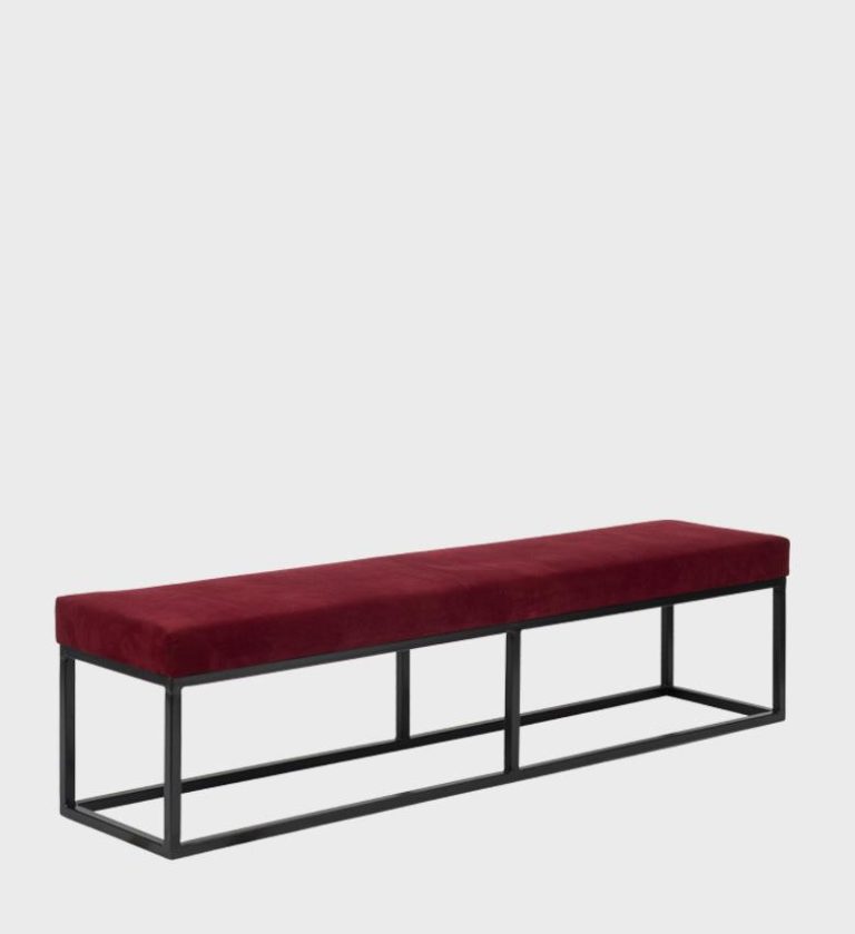 The Kelly Ottoman Flat Top embodies sleek modernism with its elongated silhouette and vibrant ochre upholstery.