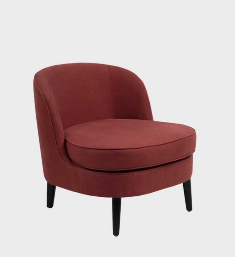 The Luca Slipper Chair embodies effortless elegance with its rounded silhouette and tailored simplicity. Upholstered in soft ivory fabric with contrasting dark piping