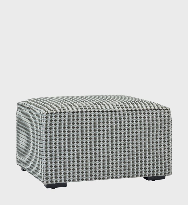 The Cube Ottoman introduces playful geometry to modern interiors with its bold circular pattern in earthy tones of brown, beige, and muted red.