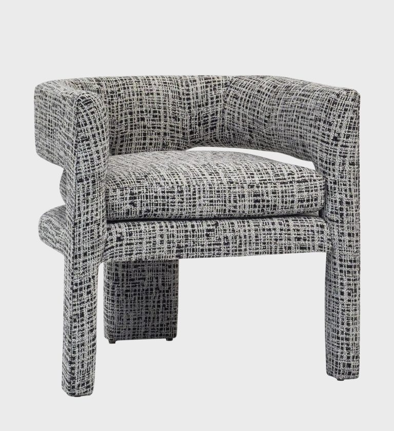 The Vogue Chair is a bold statement in contemporary design. Upholstered in a dynamic black‑and‑white crosshatch fabric, it features a sculptural curved backrest that seamlessly transitions into the arms, creating a striking silhouette.