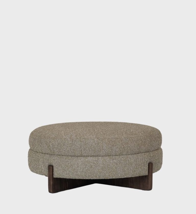 he Aria Ottoman blends organic warmth with modern simplicity. Its round, cushioned form is upholstered in a textured taupe fabric,