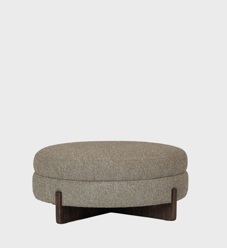 he Aria Ottoman blends organic warmth with modern simplicity. Its round, cushioned form is upholstered in a textured taupe fabric,