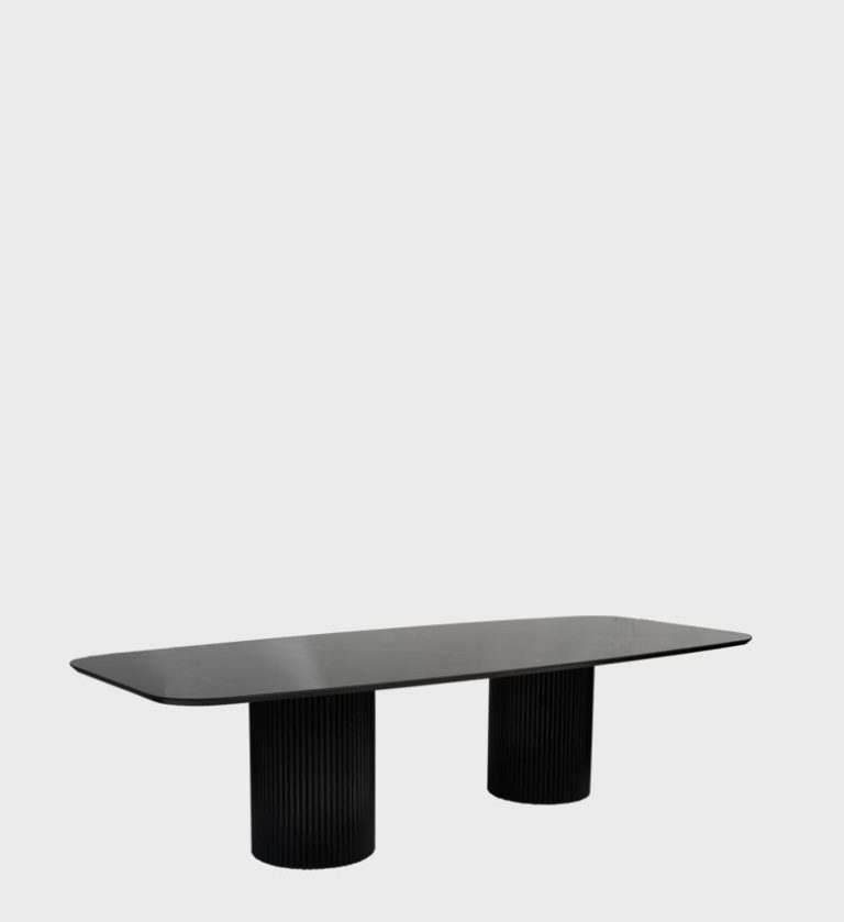 The Dolce Vita Oval Dining Table is a refined statement of modern luxury. Its smooth, marble‑effect top with soft veining rests on two cylindrical, fluted bases finished in deep black