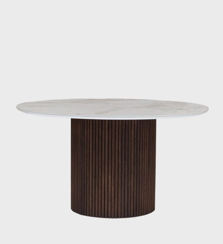 The Fluted Table is a refined centerpiece that blends sculptural form with minimalist elegance. Its round top, finished in a smooth gray surface with subtle veining, rests on a cylindrical base featuring vertical fluting that adds rhythm and texture