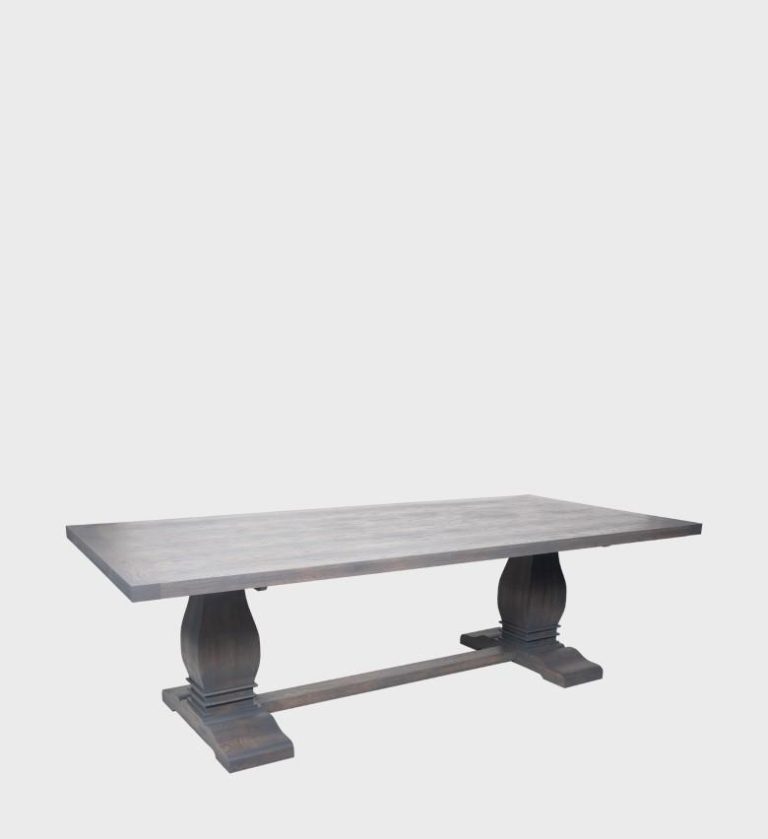 The Refectory Dining Table is a timeless piece that celebrates traditional craftsmanship and enduring design. Its broad rectangular top rests on two sculpted pedestal bases connected by a central stretcher, ensuring both stability and visual balance.