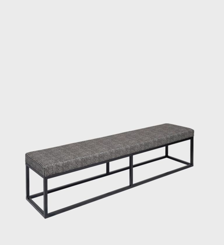 The Kelly Ottoman Steel Base blends industrial precision with refined comfort. Its tufted dark‑grey seat rests on a sleek black steel frame,