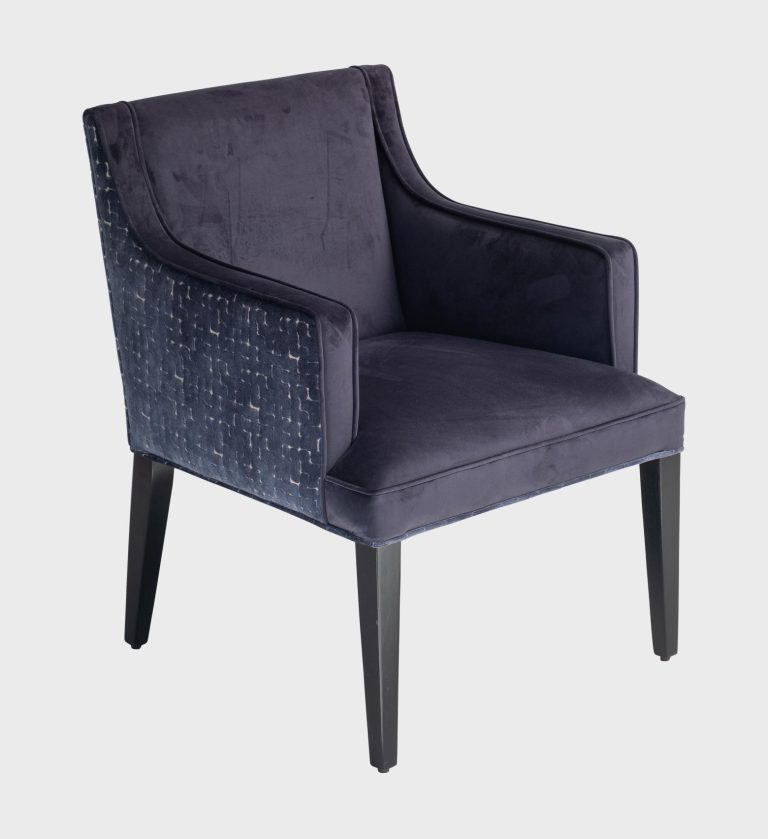 The Cape Dining Chair MD blends timeless elegance with modern craftsmanship. Its crisp ivory upholstery contrasts beautifully with the textured geometric pattern