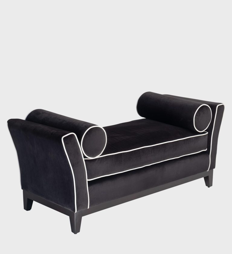 The Belinda Daybed exudes timeless sophistication with its sculpted silhouette and plush black velvet upholstery.