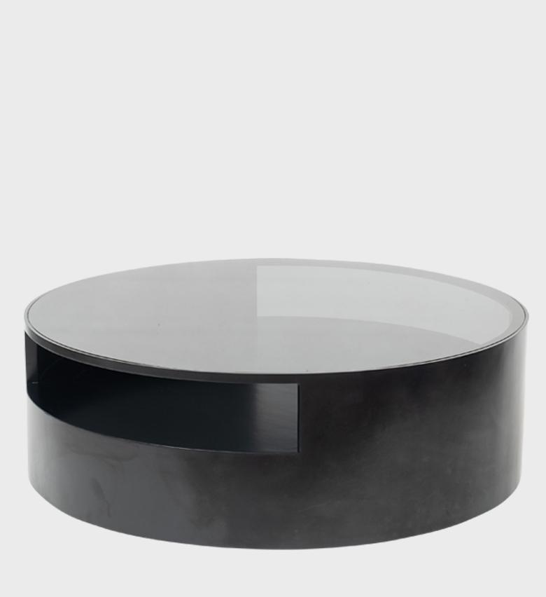 The Kenzo Coffee Table Ebony is a sleek fusion of modern design and functional elegance. Its circular form features a deep ebony finish with a smooth glass top that adds lightness and reflection.