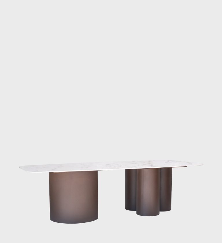 The Boulder Oval Top Dining Table is a sculptural masterpiece that merges organic form with modern sophistication. Its smooth, marble‑effect top with soft veining rests on a bold cylindrical base composition