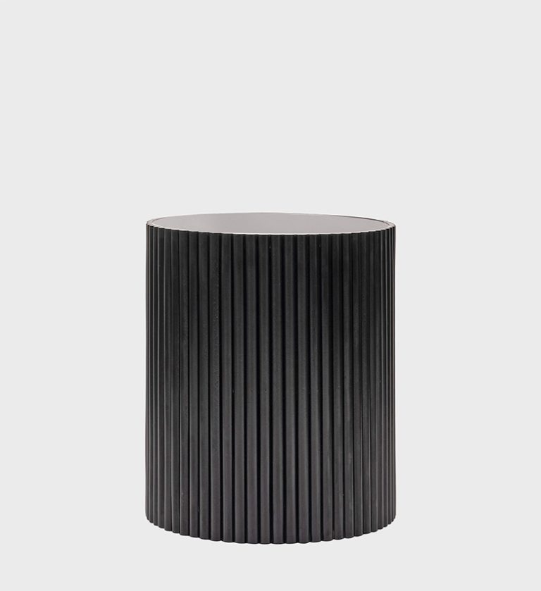 The Venice Side Table Ebony is a refined expression of modern craftsmanship. Its cylindrical silhouette features vertical wooden fluting that adds rhythm and depth