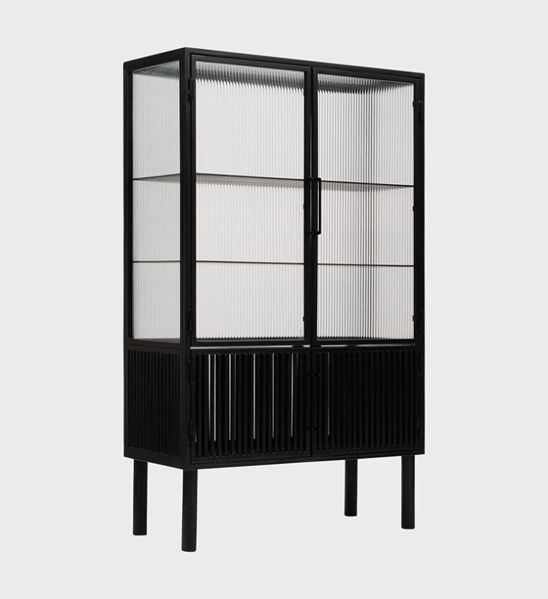 The Lauren Cabinet is a refined showcase of modern craftsmanship. Its tall, structured frame combines sleek black wood with vertically fluted glass panels, creating a dynamic interplay of light and shadow.
