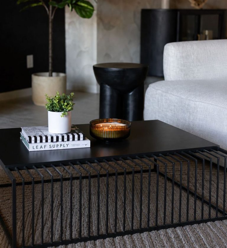 The Latitude Coffee Table is a striking study in contrast and balance. Its rectangular form combines two distinct surfaces — a smooth white marble top and a textured black slatted section