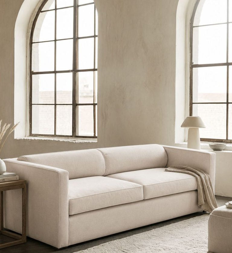 The Sophie Sofa is a refined expression of modern simplicity and comfort. Upholstered in a soft, light‑gray fabric, it features clean lines and a low, structured profile that exudes understated elegance.