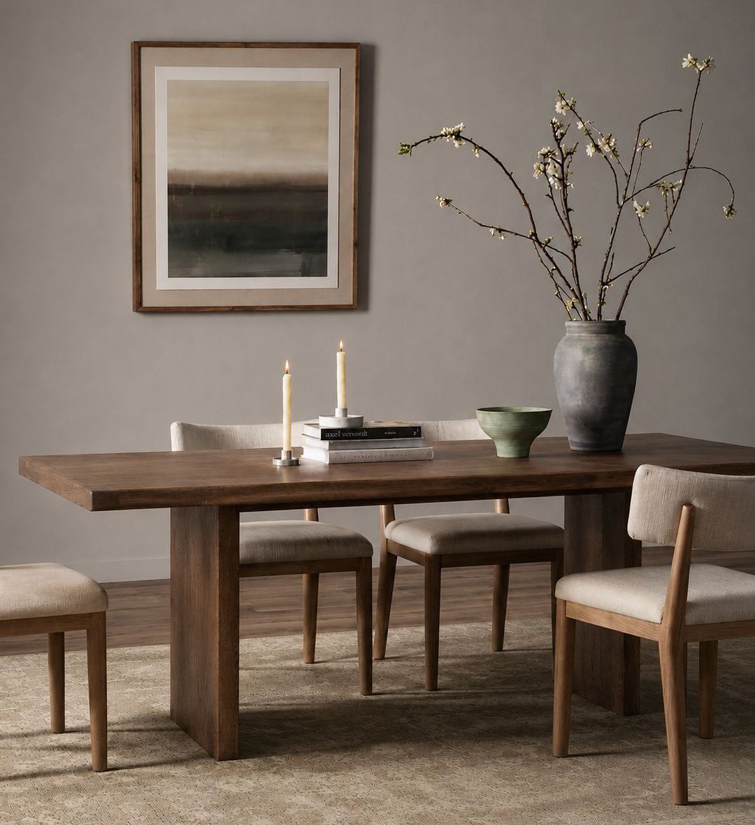The Sweni Dining Table embodies timeless craftsmanship and understated elegance. Its long rectangular top, made from richly grained dark wood, rests on two solid slab legs that emphasize strength and simplicity.