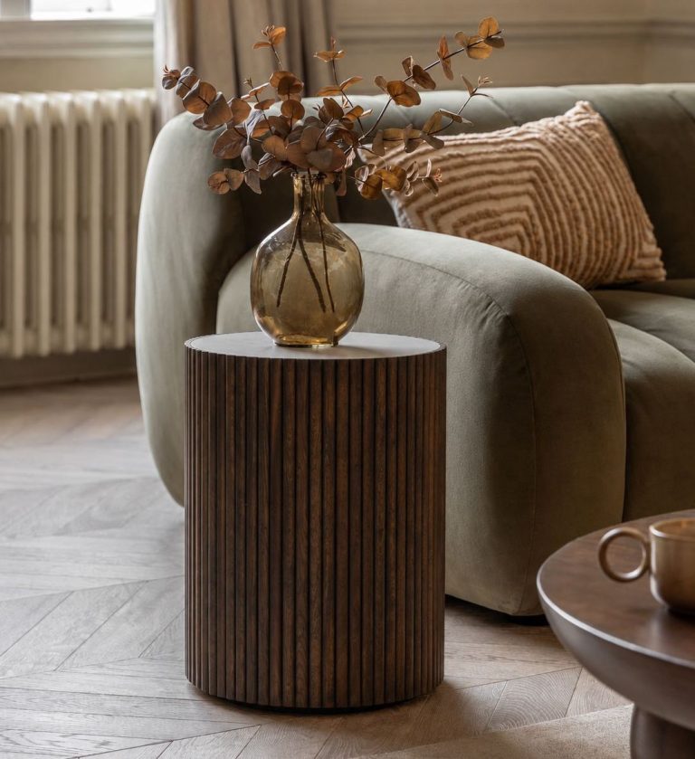 The Venice Side Table Ebony is a refined expression of modern craftsmanship. Its cylindrical silhouette features vertical wooden fluting that adds rhythm and depth