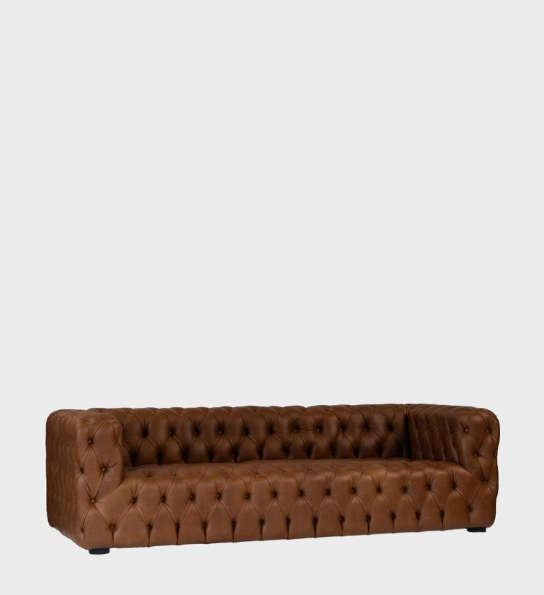 The Kravitz Sofa is a bold reinterpretation of classic tufted luxury. Upholstered in rich cognac‑brown leather, it features deep diamond buttoning across its low, structured frame