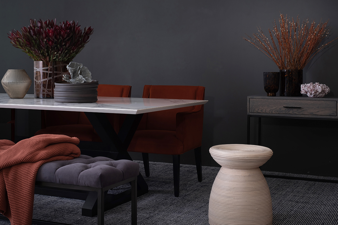 Dark dining room with red accents and decorative vases featuring flowers