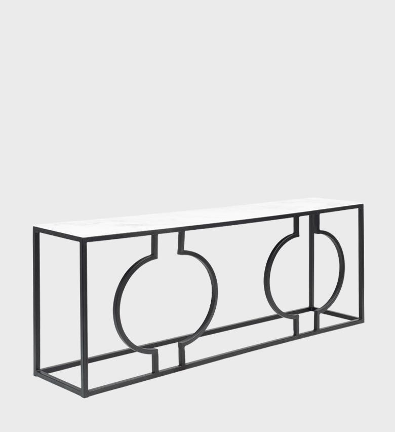 The Elba Console Large is a striking piece of modern artistry. Its open black metal frame features bold circular motifs that create a sculptural, geometric rhythm, while the smooth white top adds a crisp contrast