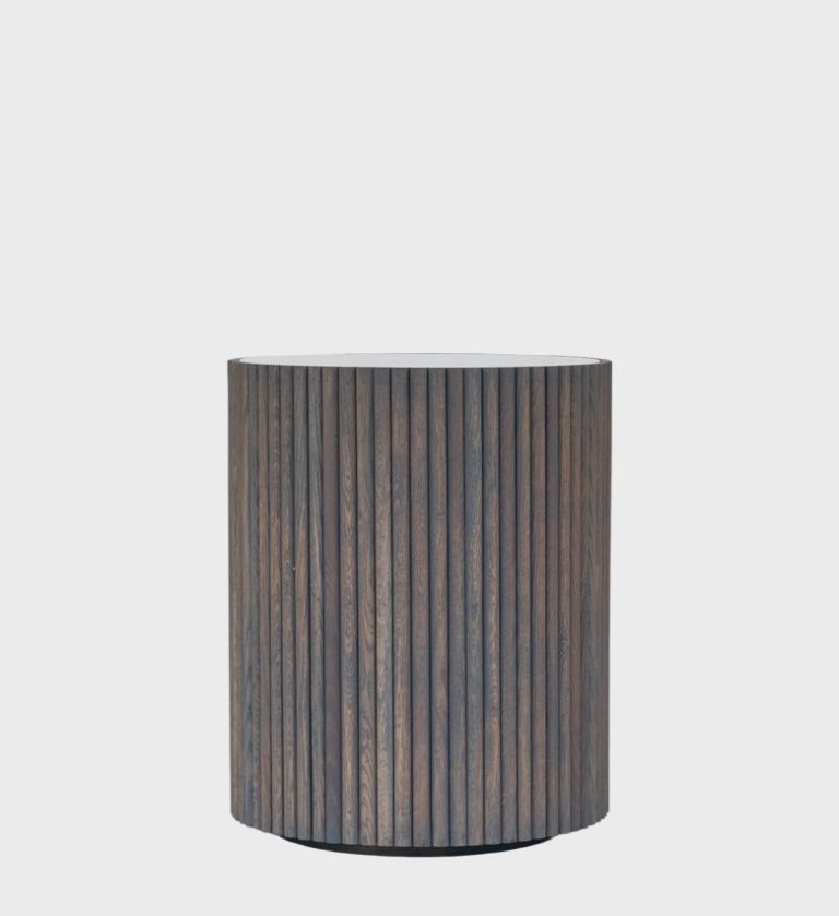 The Venice Side Table Storm is a refined expression of modern craftsmanship. Its cylindrical silhouette features vertical wooden fluting that adds rhythm and depth,