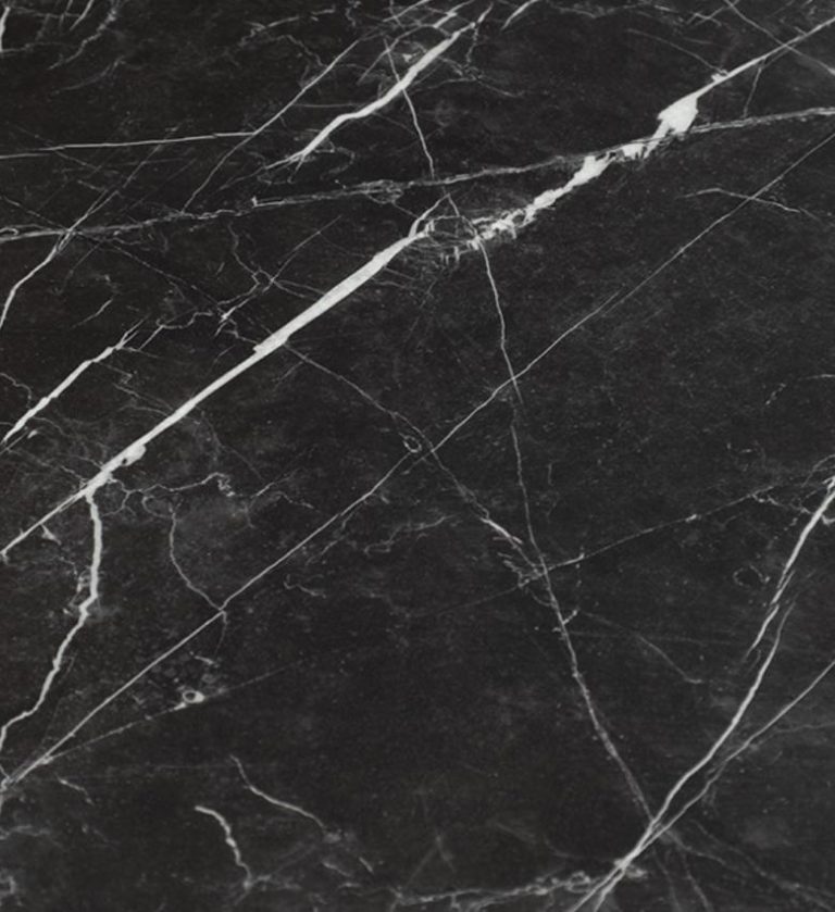 The Provocative Dining Table is a bold fusion of strength and sophistication. Its expansive rectangular top, crafted from polished white marble with delicate gray veining, rests on a striking black X‑frame base.