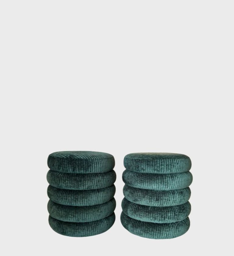 The Ripple Ottoman is a playful yet refined accent piece defined by its sculptural rhythm and plush texture. Each ottoman features stacked, rounded layers upholstered in rich teal velvet with a subtle ribbed pattern that enhances depth and tactility.